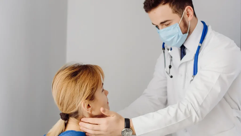 A doctor examines a patient during a medical appointment in a clinic.