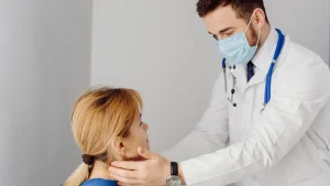 A doctor examines a patient during a medical appointment in a clinic.