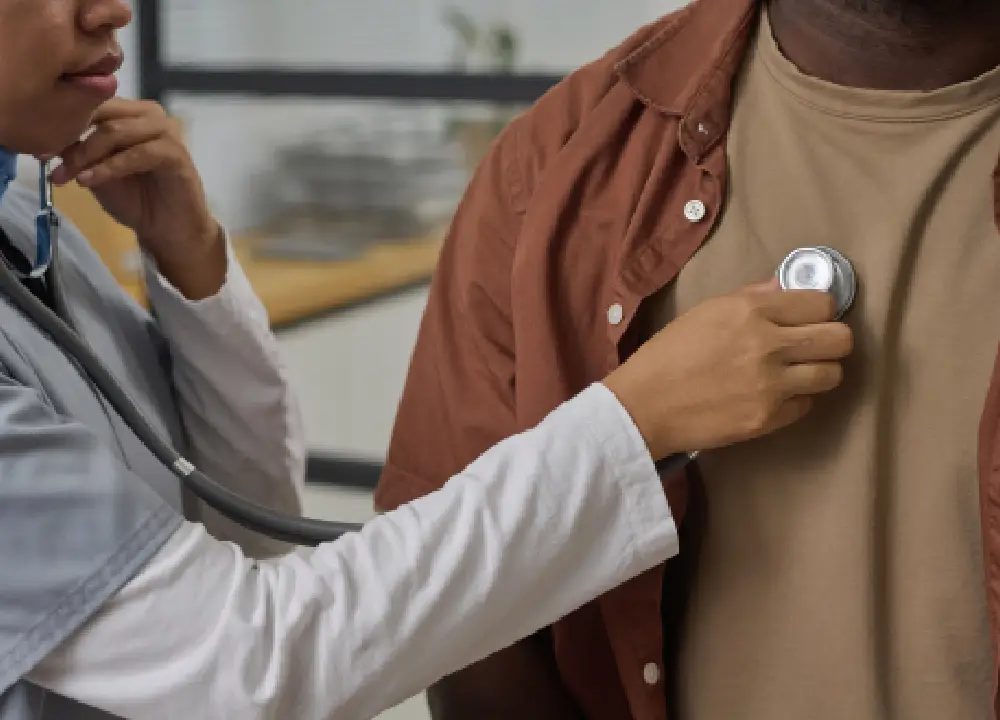 Doctor examining a patient’s chest and ribs to diagnose a rib injury.