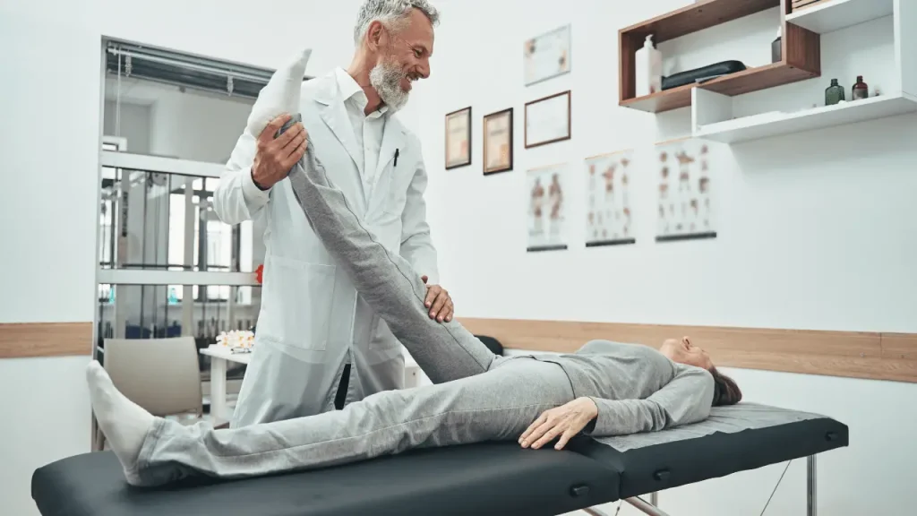 Doctor performing chiropractic adjustment on a patient with back pain after a car accident.