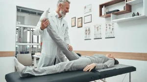 Doctor performing chiropractic adjustment on a patient with back pain after a car accident.