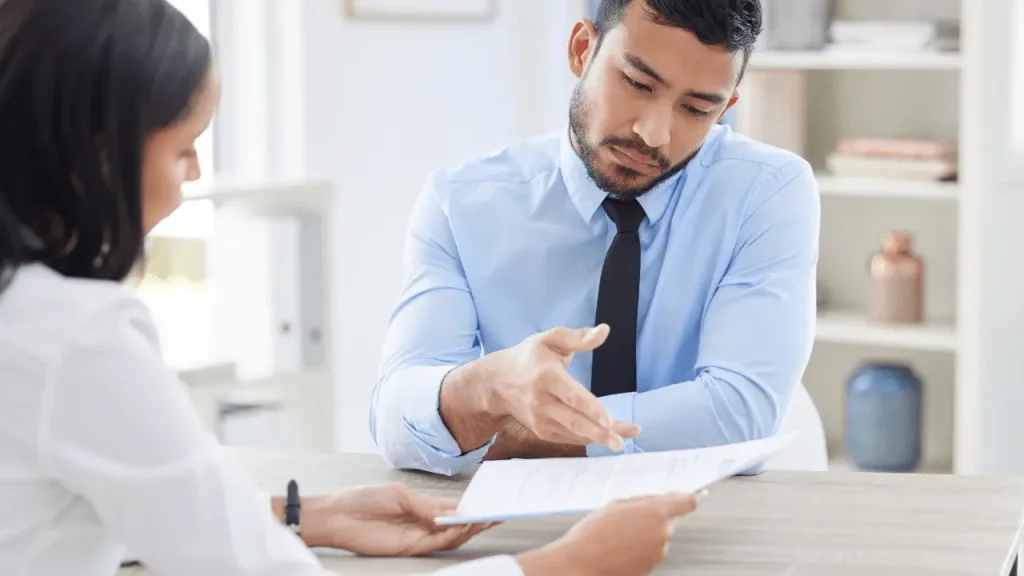 Personal injury lawyer discussing car accident claim with insurance adjuster in Houston.